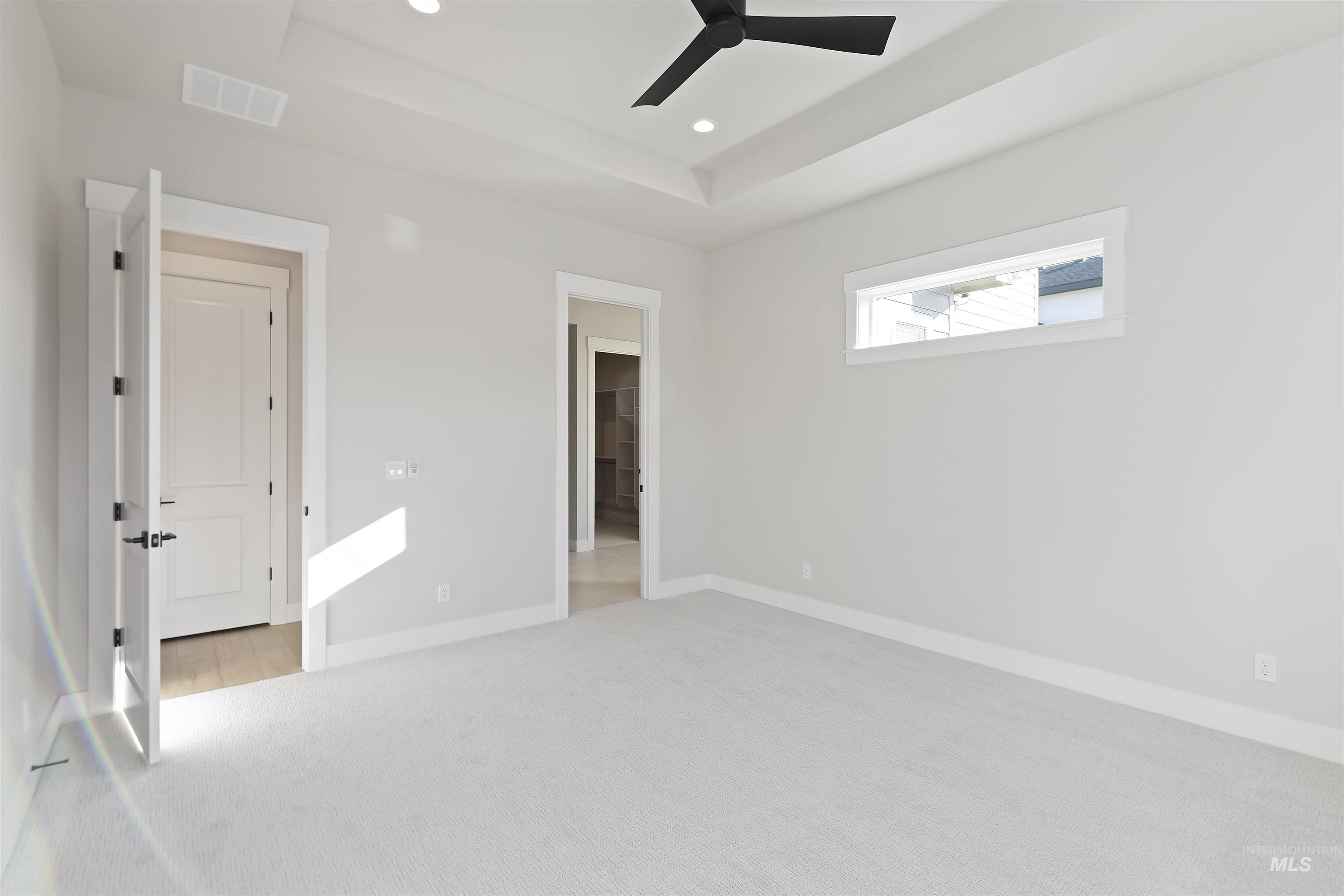 2247 East Blakehurst Street Kuna, ID 83634 - Photo 14 of 27 Featuring a raised ceiling, carpet flooring, ceiling fan, and recessed lighting