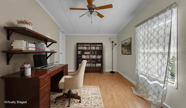 a view of a workspace with furniture and a window
