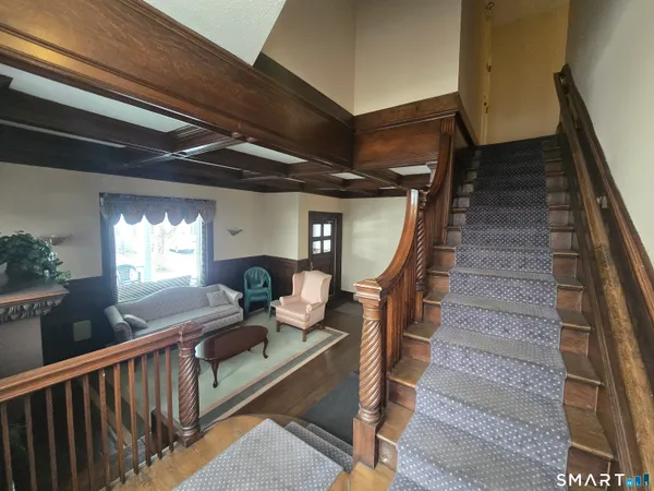 a view of entryway and hall with wooden floor