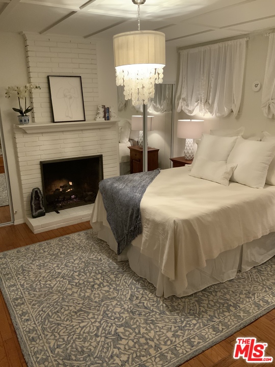 3969 Alla Road Los Angeles, CA 90066 - Photo 22 of 28 a bed sitting in a bedroom and chandelier