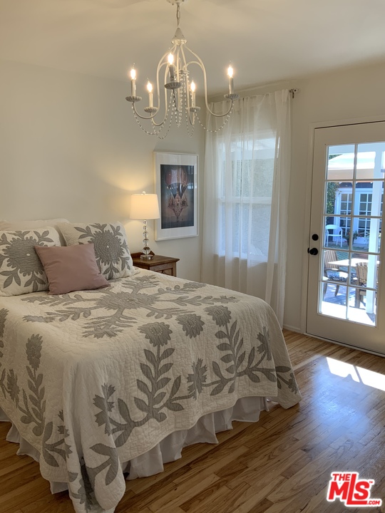 3969 Alla Road Los Angeles, CA 90066 - Photo 10 of 28 a spacious bedroom with a bed and a chandelier