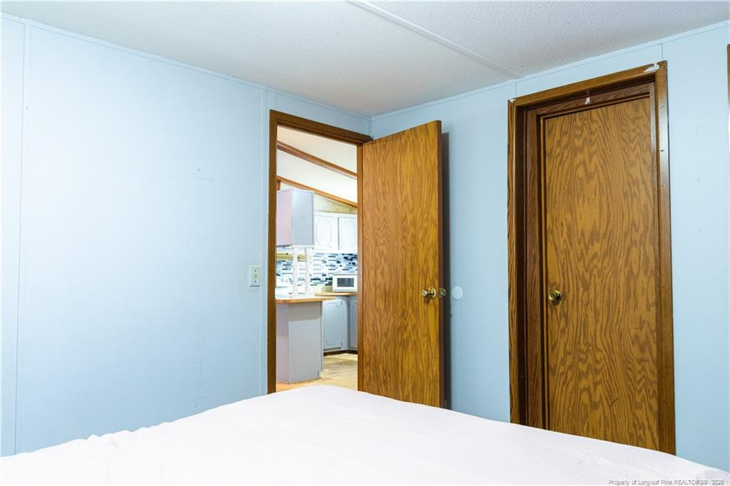 231 Knight Lane Autryville, NC 28318 - Photo 22 of 27 a bedroom with a bed and a window