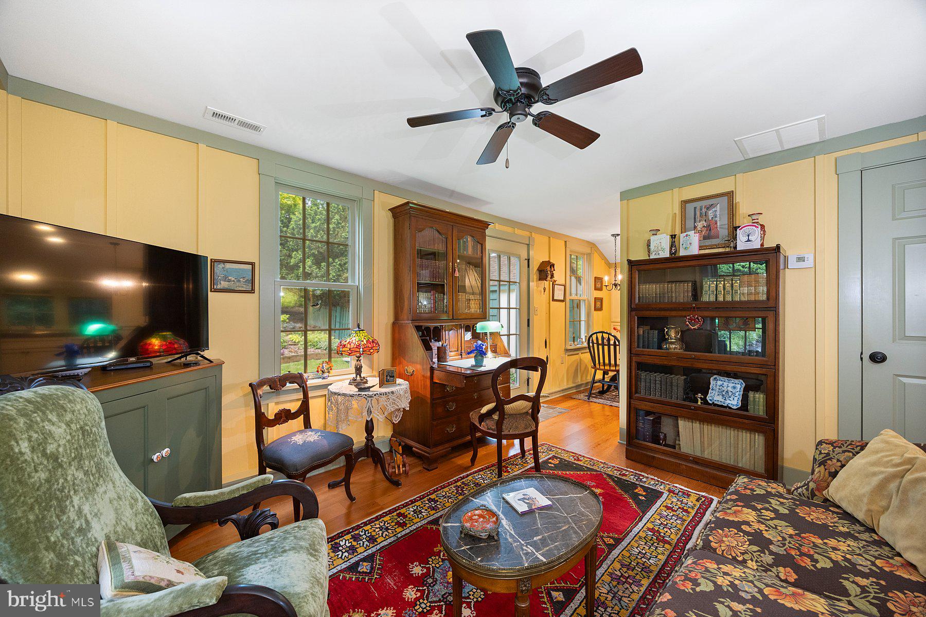 13704 Bardon Road Phoenix, MD 21131 - Photo 27 of 88 a living room with furniture a flat screen tv and a floor to ceiling window