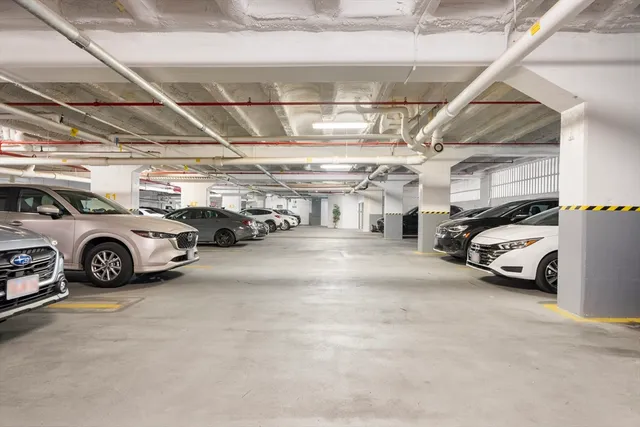 a view of parking garage with cars parked