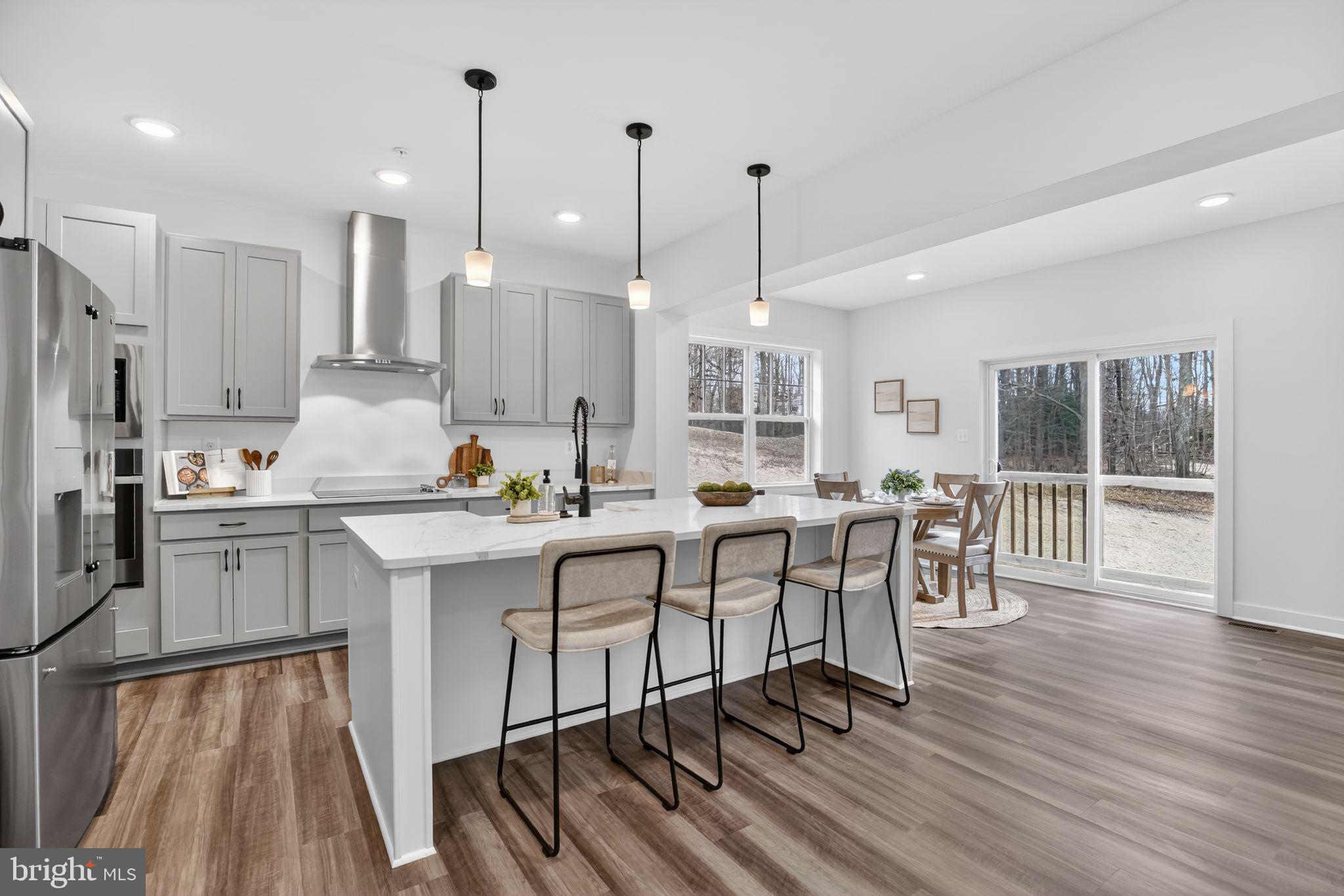4747 Bryantown Road Waldorf, MD 20601 - Photo 11 of 62 an open kitchen with wooden floor and stainless steel appliances