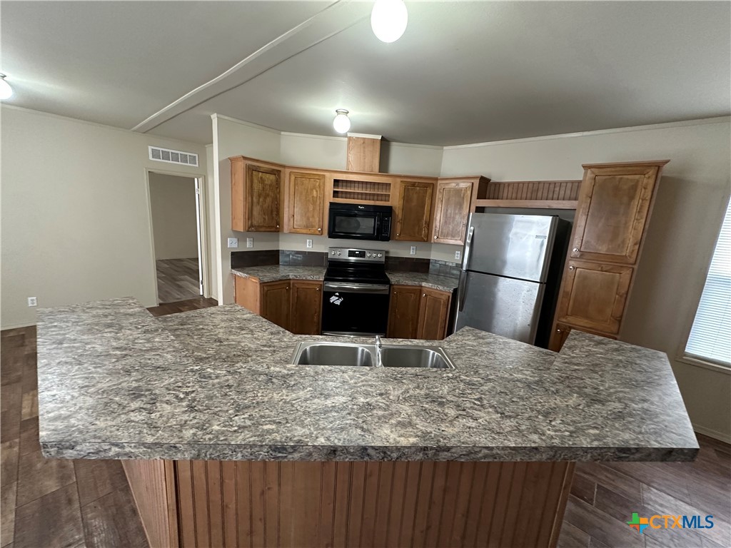 532 Post Office Street Kingsbury, TX 78638 - Photo 11 of 18 a kitchen with kitchen island a counter top space cabinets and stainless steel appliances