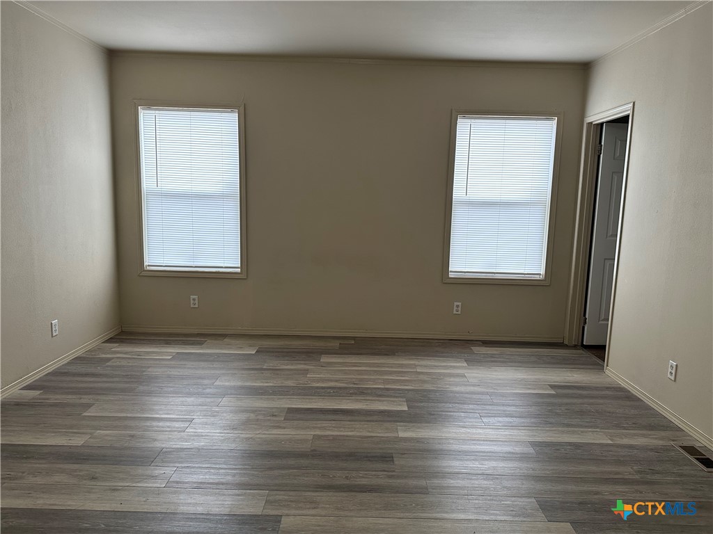 532 Post Office Street Kingsbury, TX 78638 - Photo 14 of 18 a view of an empty room with wooden floor and a window