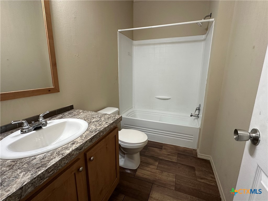 532 Post Office Street Kingsbury, TX 78638 - Photo 18 of 18 a bathroom with a granite countertop sink toilet and shower