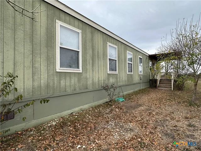 a house view with a backyard space