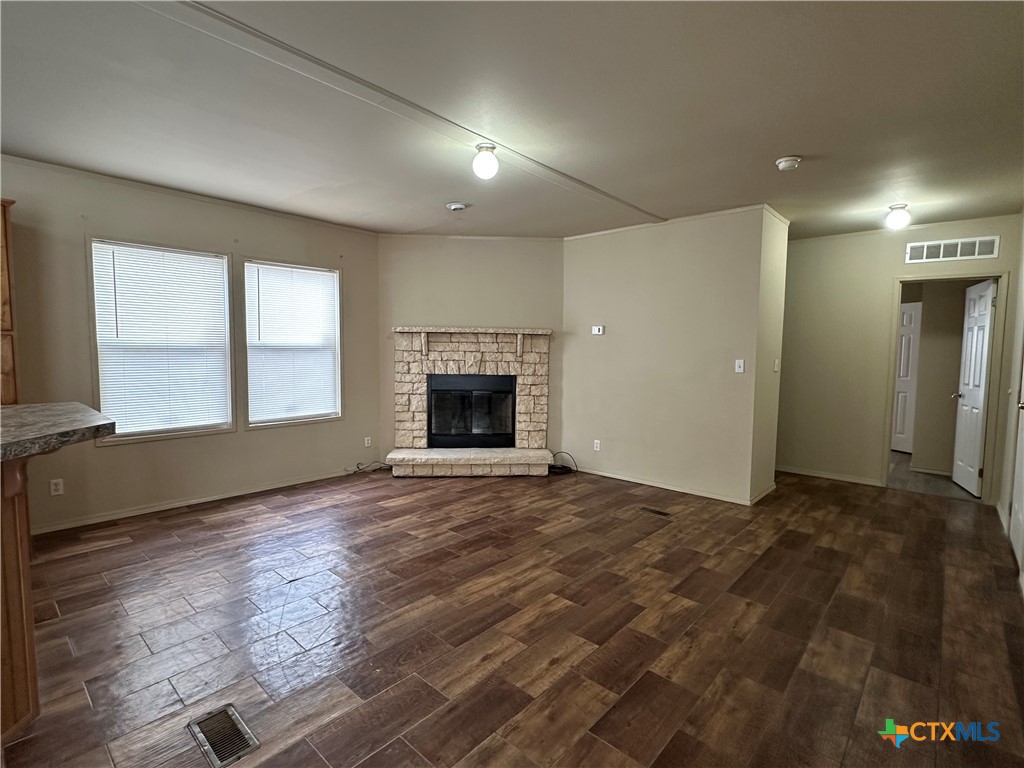 532 Post Office Street Kingsbury, TX 78638 - Photo 8 of 18 an empty room with windows and fireplace