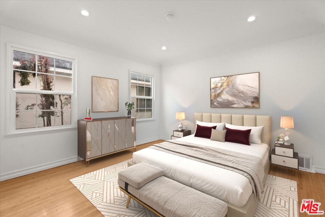 207 South Reeves Drive Beverly Hills, CA 90212 - Photo 10 of 13 a bedroom with a large bed and a window
