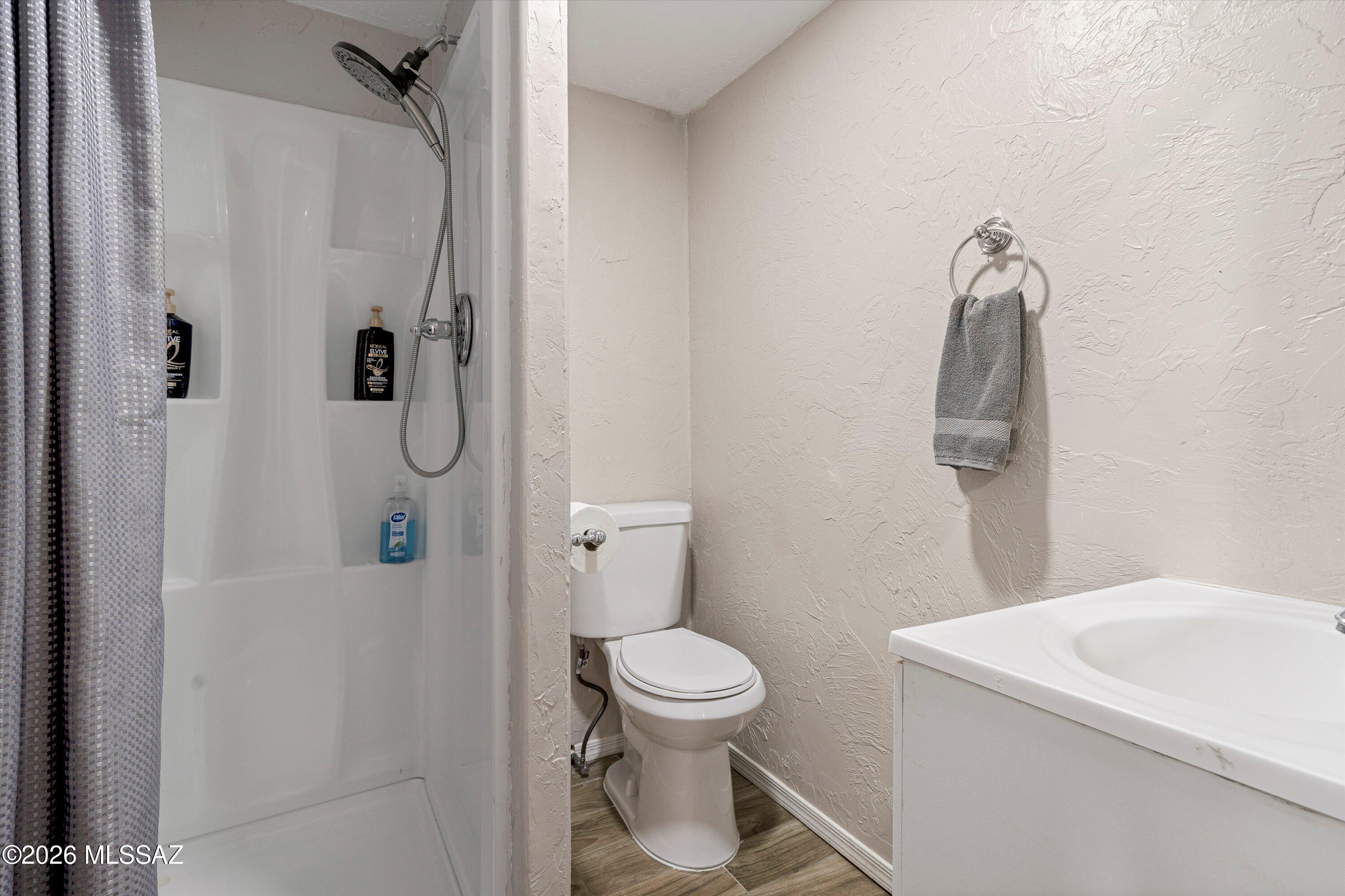 2841 North Richey Boulevard Tucson, AZ 85716 - Photo 19 of 30 a bathroom with a toilet sink and shower