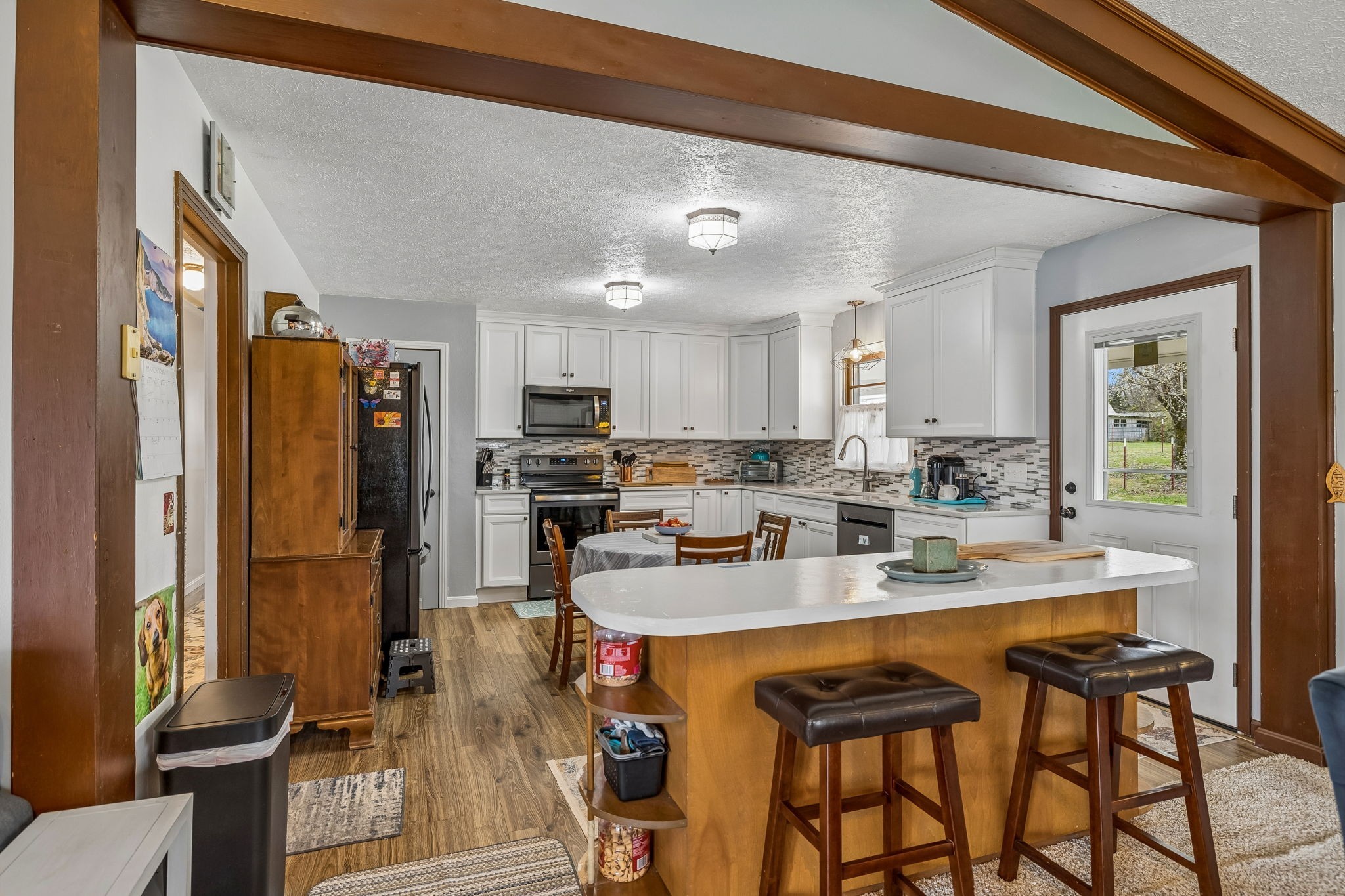 6200 Pinewood Road Nunnelly, TN 37137 - Photo 48 of 57 a kitchen with stainless steel appliances kitchen island granite countertop a refrigerator and cabinets