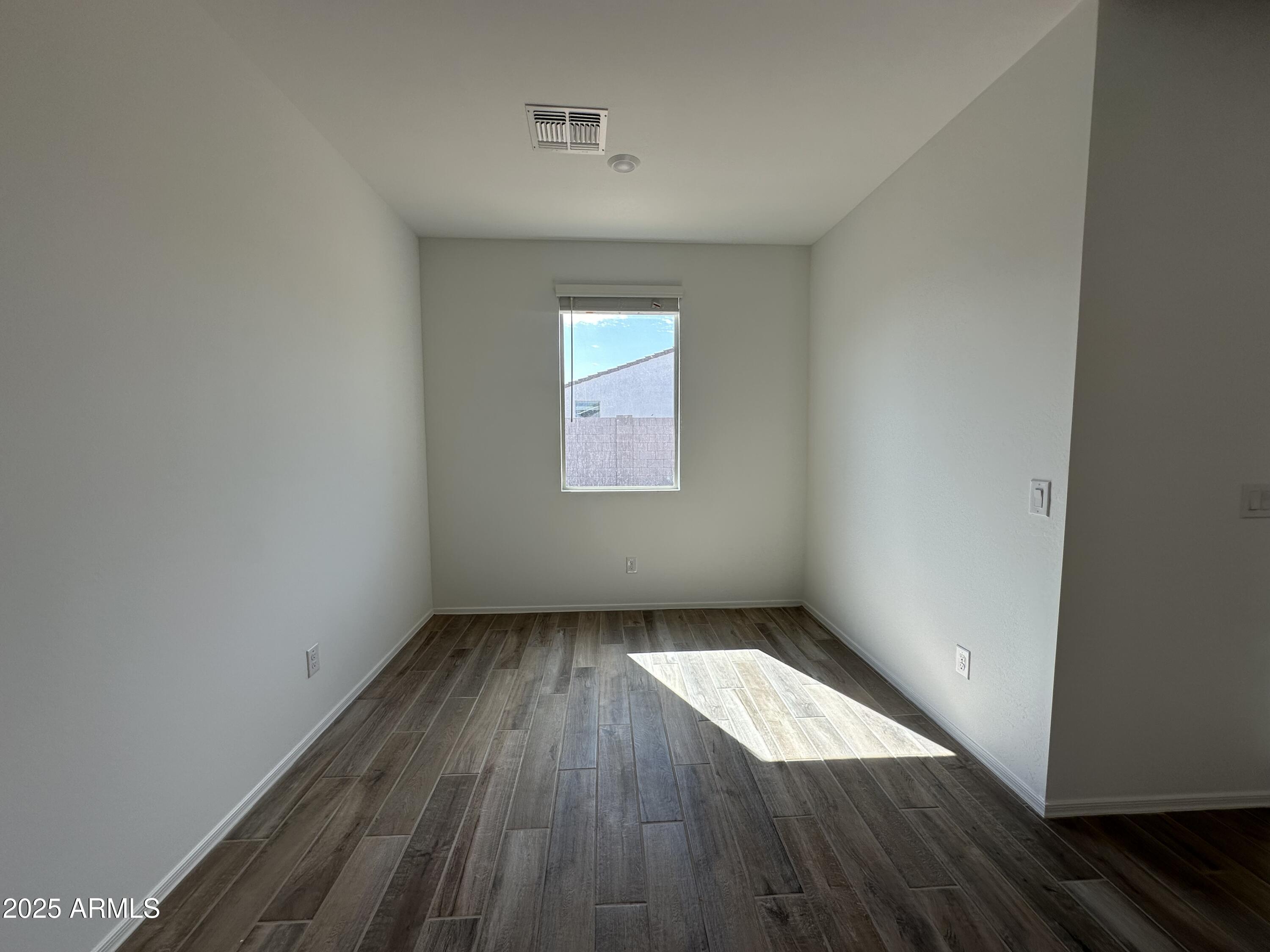 47691 West Moeller Road Maricopa, AZ 85139 - Photo 14 of 31 an empty room with wooden floor and windows