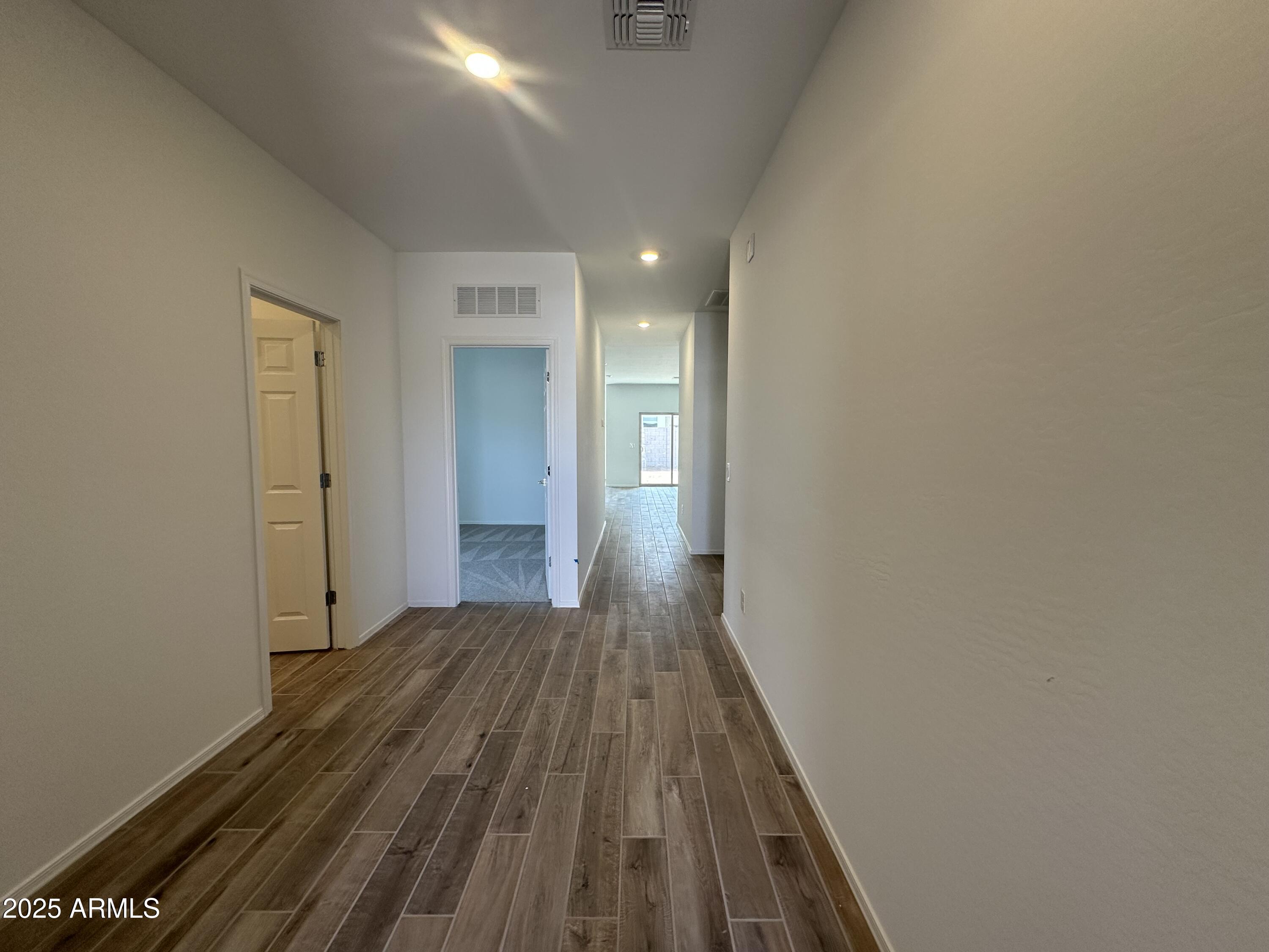 47691 West Moeller Road Maricopa, AZ 85139 - Photo 3 of 31 a view of a room with wooden floor and a bathroom