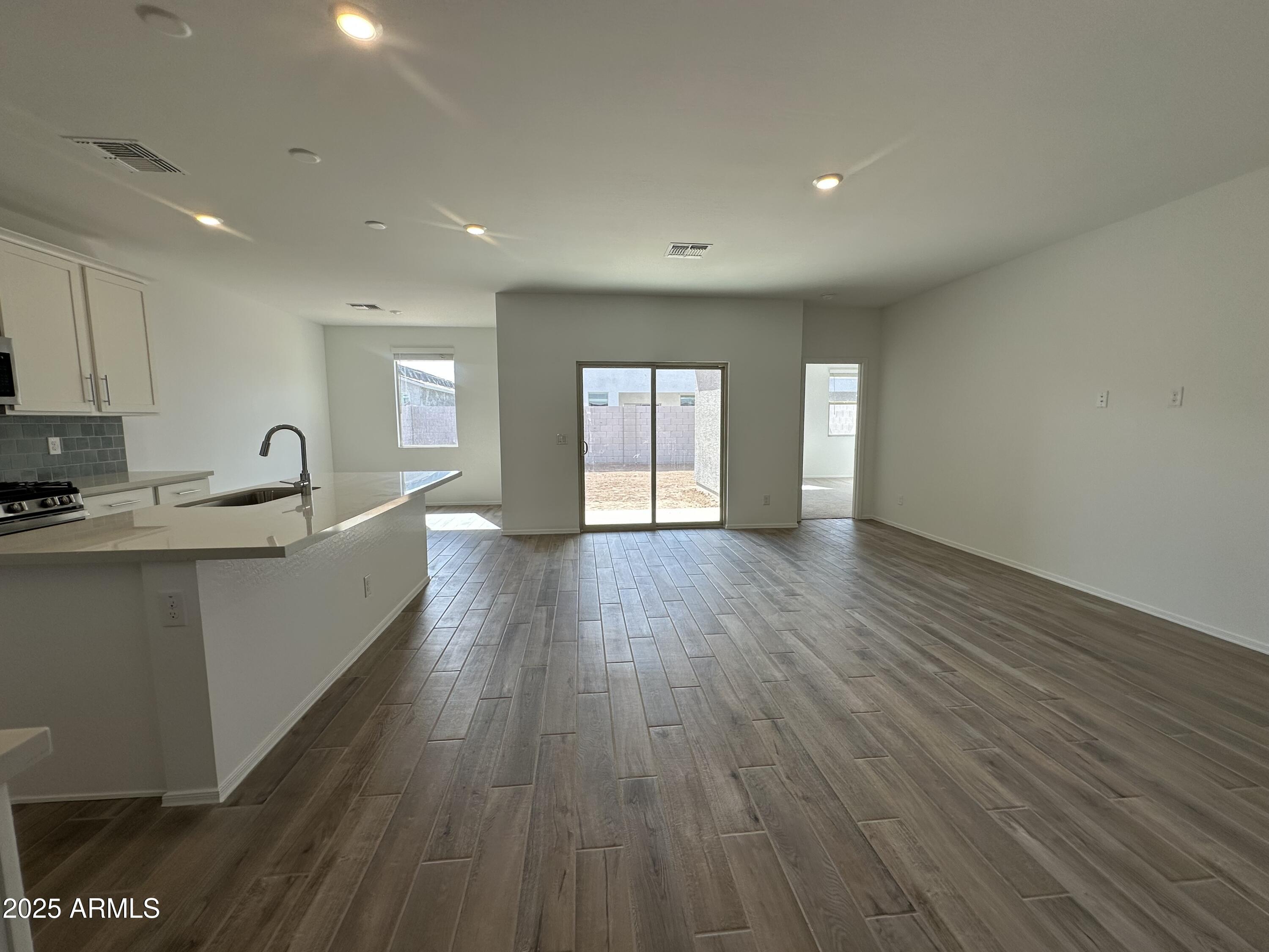 47691 West Moeller Road Maricopa, AZ 85139 - Photo 9 of 31 a view of an empty room with wooden floor and a window