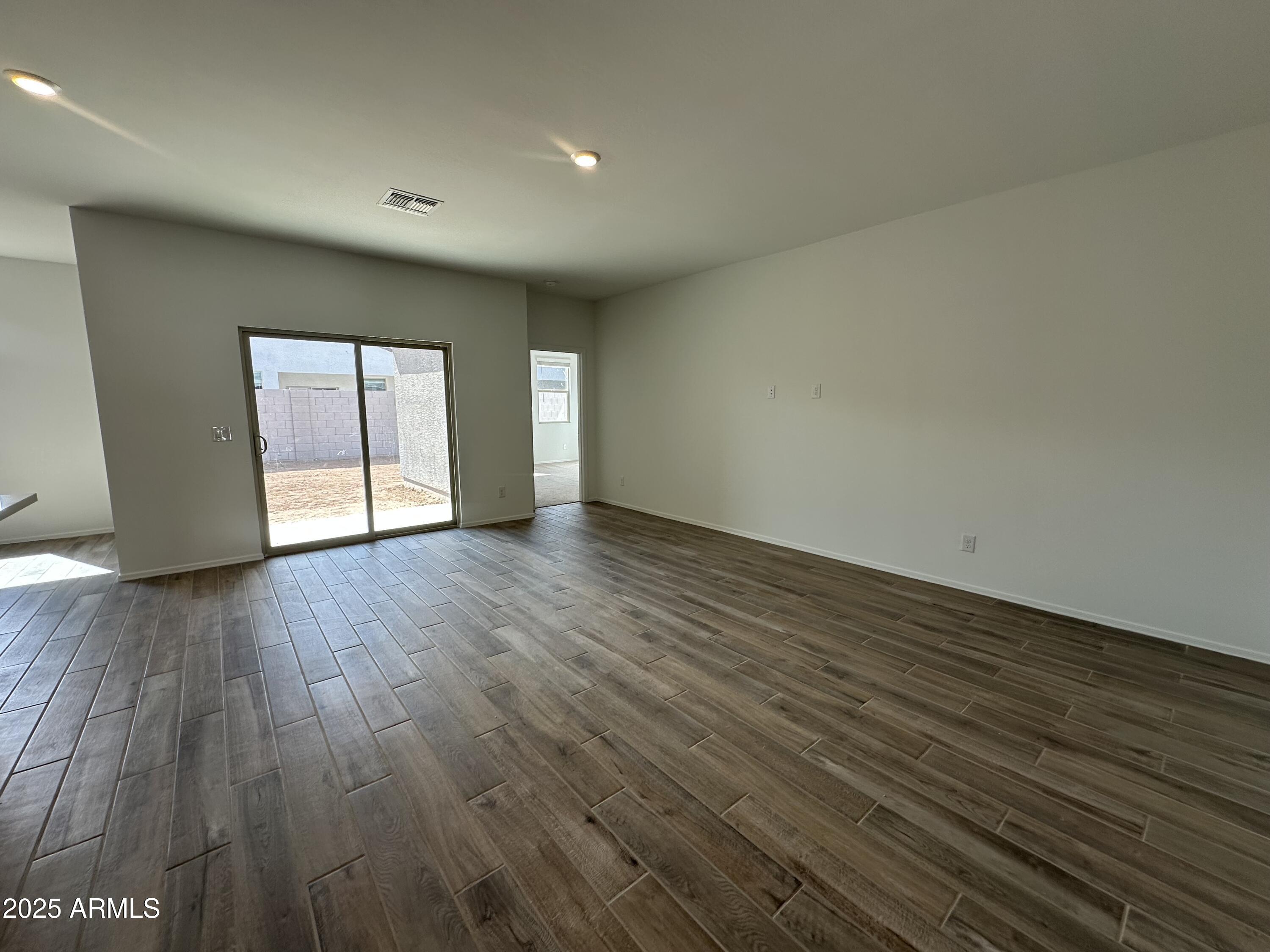 47691 West Moeller Road Maricopa, AZ 85139 - Photo 10 of 31 a view of an empty room with wooden floor and window
