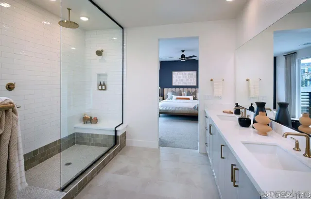a en suite bathroom with a tub sink and mirror