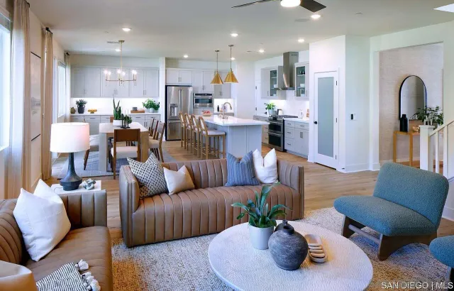 a living room with furniture kitchen and a potted plant
