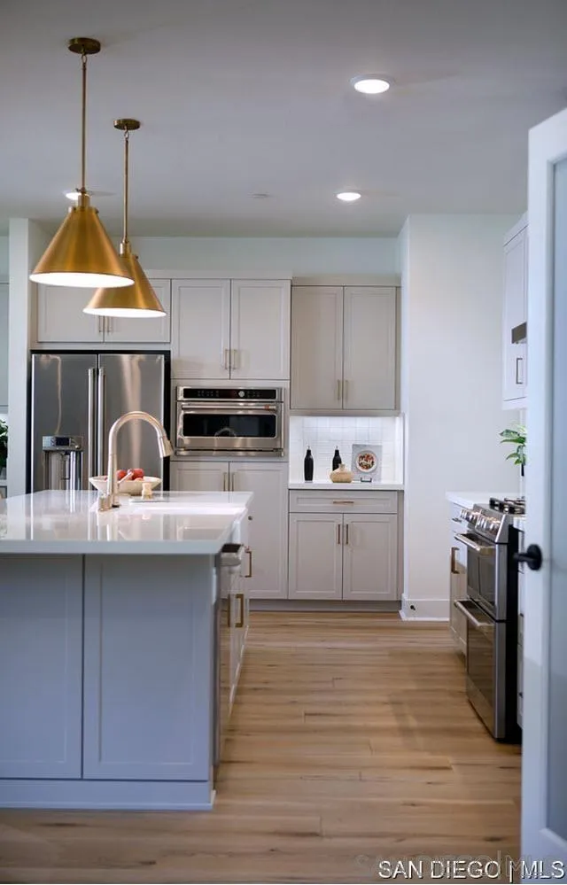 709 Meadowood Street, Unit 328 Fallbrook, CA 92028 - Photo 6 of 11 a kitchen with stainless steel appliances granite countertop a sink a stove and refrigerator