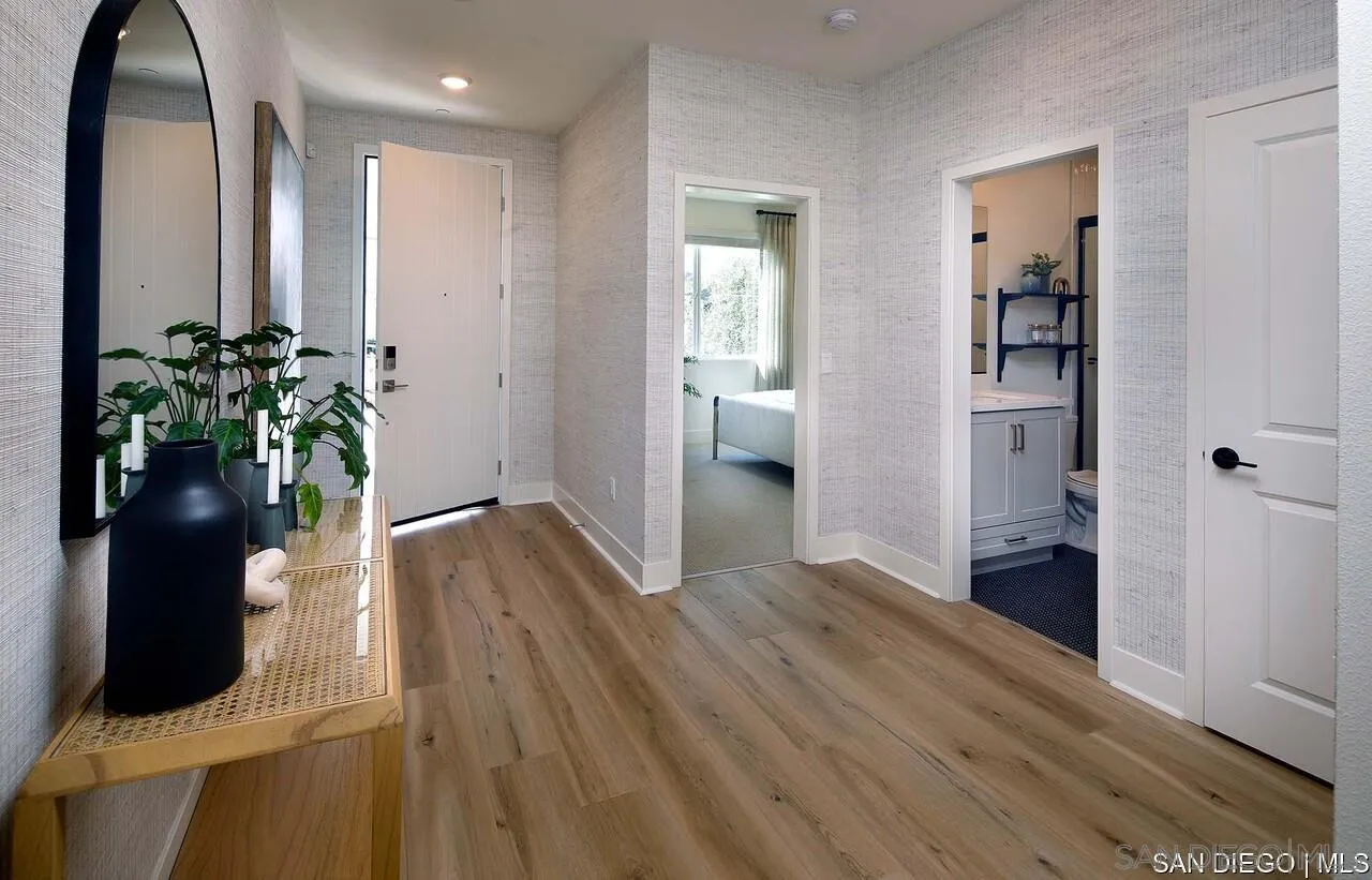 709 Meadowood Street, Unit 328 Fallbrook, CA 92028 - Photo 9 of 11 a view of hallway with wooden floor and a potted plant