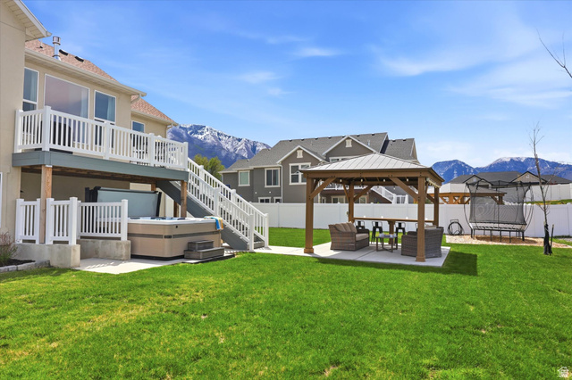 283 North 500 West Mapleton, UT 84664 - Photo 83 of 102 Fenced backyard with a patio, outdoor lounge area, a gazebo, a trampoline, and a deck with mountain view.