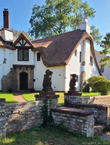 a front view of a house with swimming pool and a yard