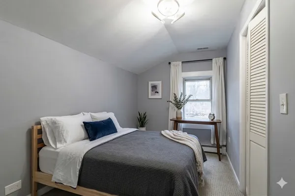 a bedroom with a bed and a window
