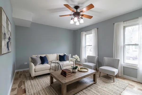 a living room with furniture and a chandelier