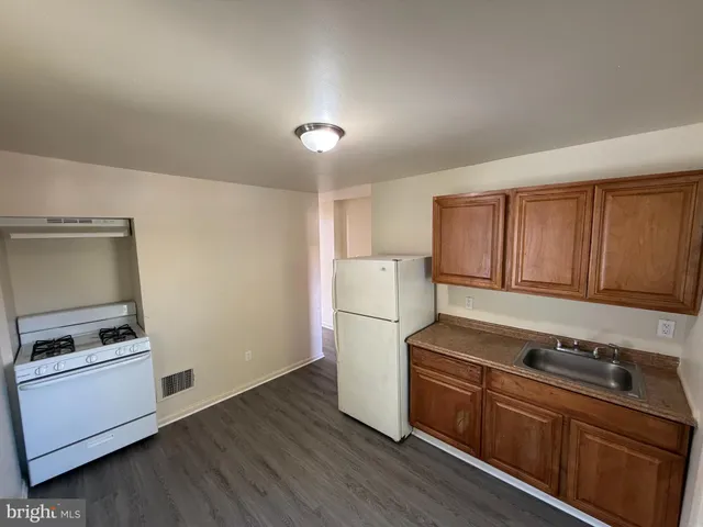 a kitchen with a refrigerator stove and white cabinets