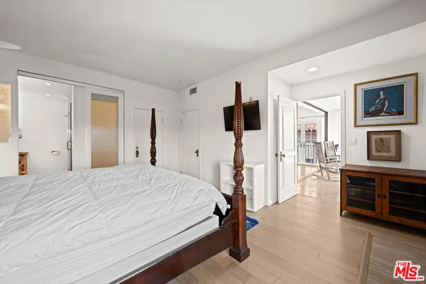 a bedroom with a bed and a flat screen tv