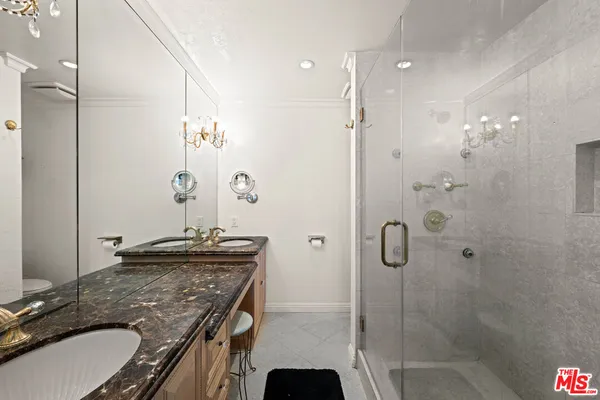 a bathroom with a granite countertop sink a shower and a mirror