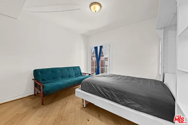 a bedroom with a bed and a couch