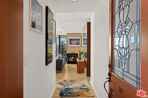a view of a livingroom with furniture and floor to ceiling window