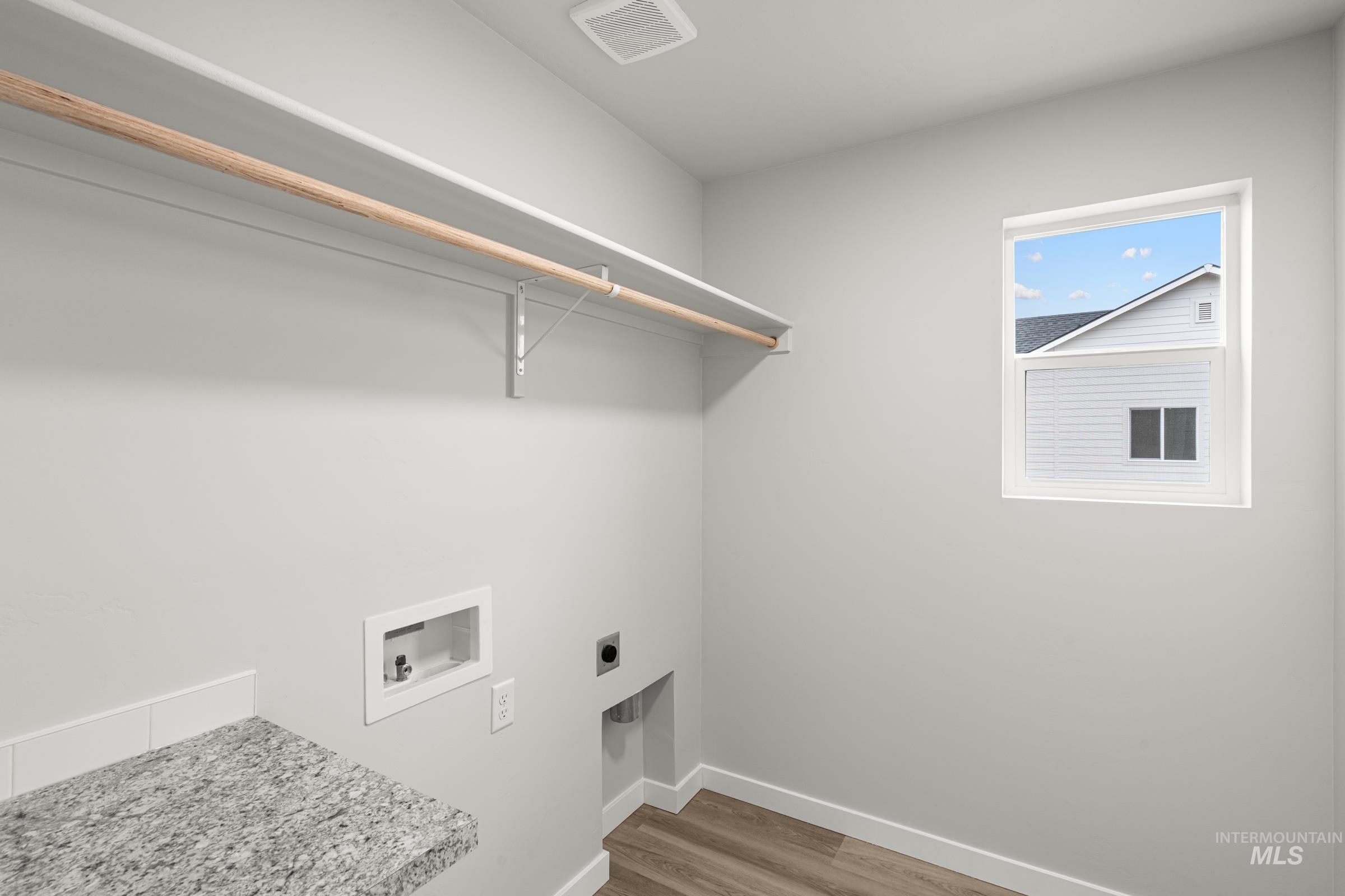 13693 Redway Court Caldwell, ID 83607 - Photo 15 of 25 Laundry room with light wood-style floors, hookup for a washing machine, and electric dryer hookup