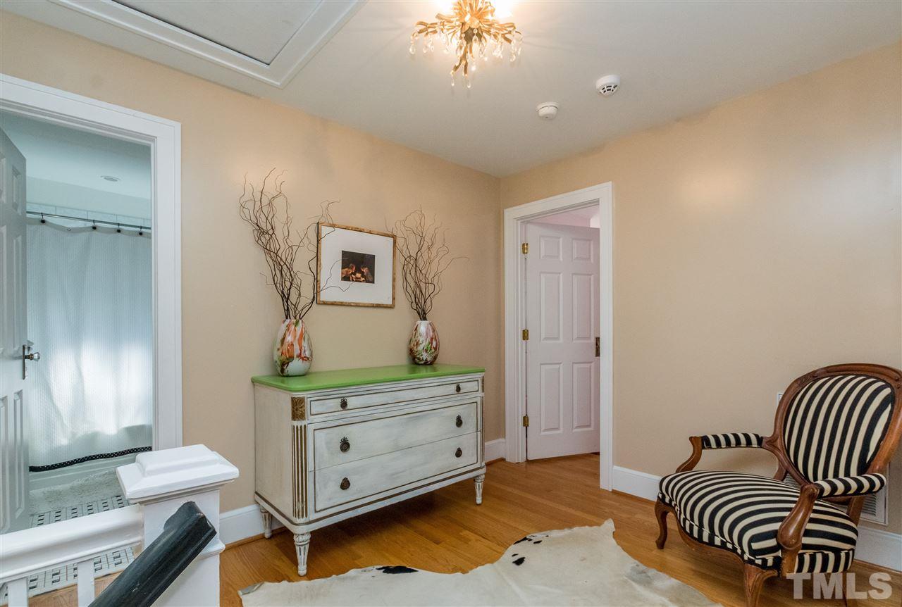 3205 Merriman Avenue Raleigh, NC 27607 - Photo 18 of 30 a bedroom with a bed and a chandelier