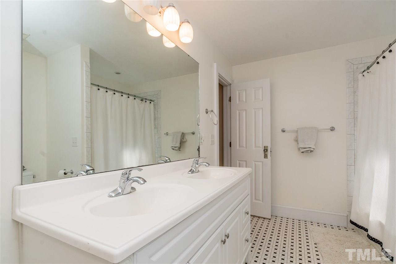 3205 Merriman Avenue Raleigh, NC 27607 - Photo 21 of 30 a bathroom with a sink a mirror and a shower