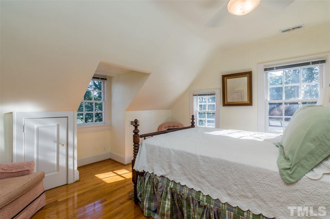 3205 Merriman Avenue Raleigh, NC 27607 - Photo 22 of 30 a bedroom with a bed and a chandelier