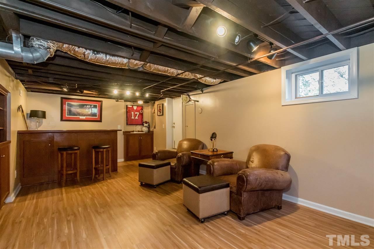 3205 Merriman Avenue Raleigh, NC 27607 - Photo 24 of 30 a living room with furniture and a wooden floor