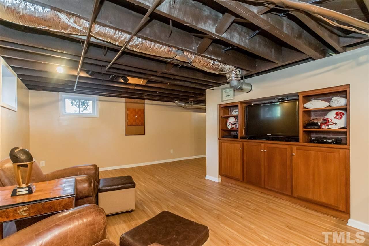 3205 Merriman Avenue Raleigh, NC 27607 - Photo 25 of 30 a living room with furniture and a flat screen tv