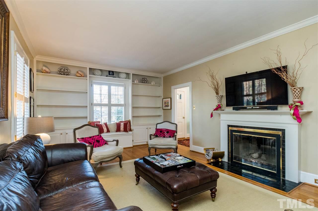 3205 Merriman Avenue Raleigh, NC 27607 - Photo 7 of 30 a living room with furniture flat screen tv and a fireplace