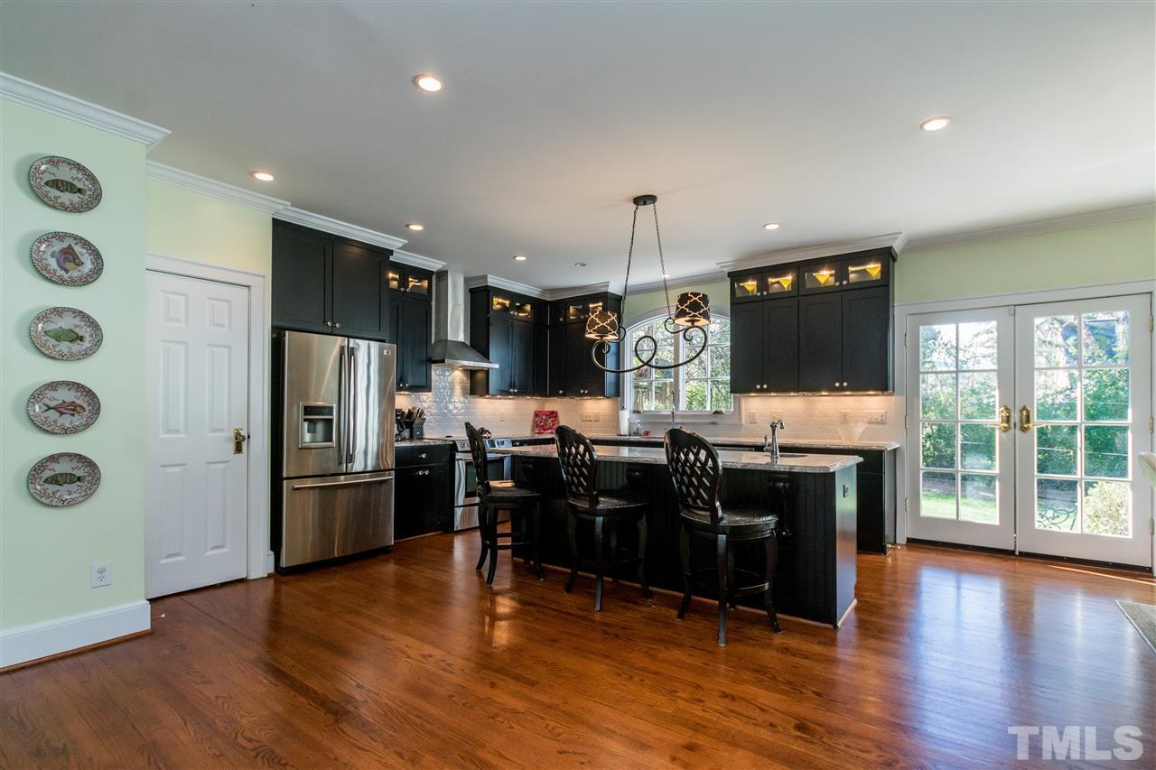 3205 Merriman Avenue Raleigh, NC 27607 - Photo 9 of 30 a view of a kitchen with refrigerator microwave and stove top oven