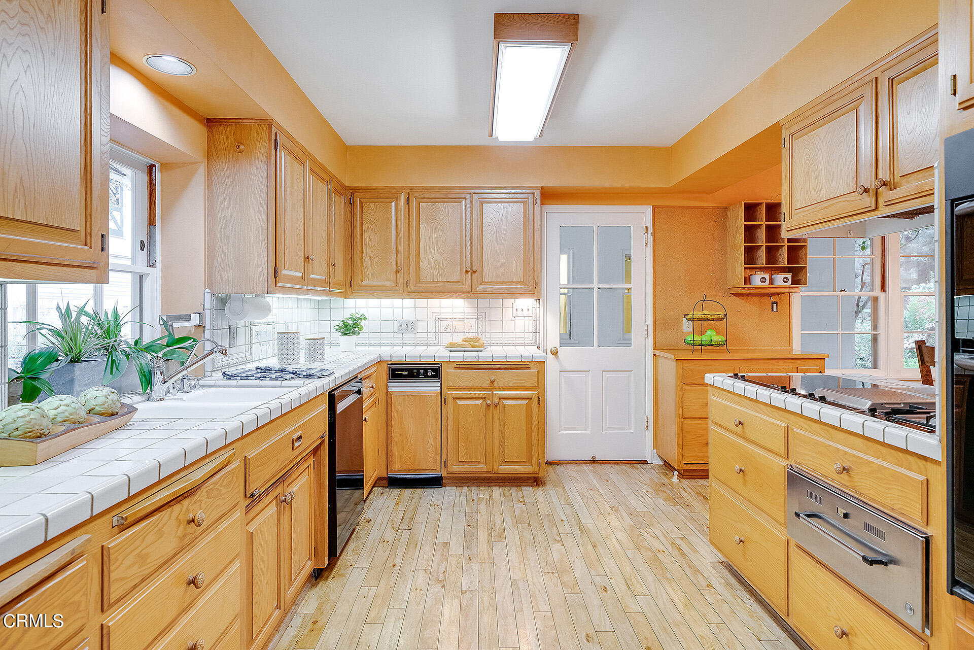 2035 South Oak Knoll Avenue San Marino, CA 91108 - Photo 14 of 29 a kitchen with a sink a counter top space stainless steel appliances and cabinets