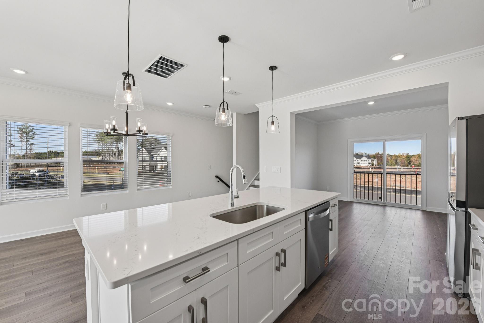 343 Golden Maple Court Fort Mill, SC 29708 - Photo 11 of 19 a spacious kitchen with stainless steel appliances granite countertop a sink dishwasher and a wooden floor with kitchen view