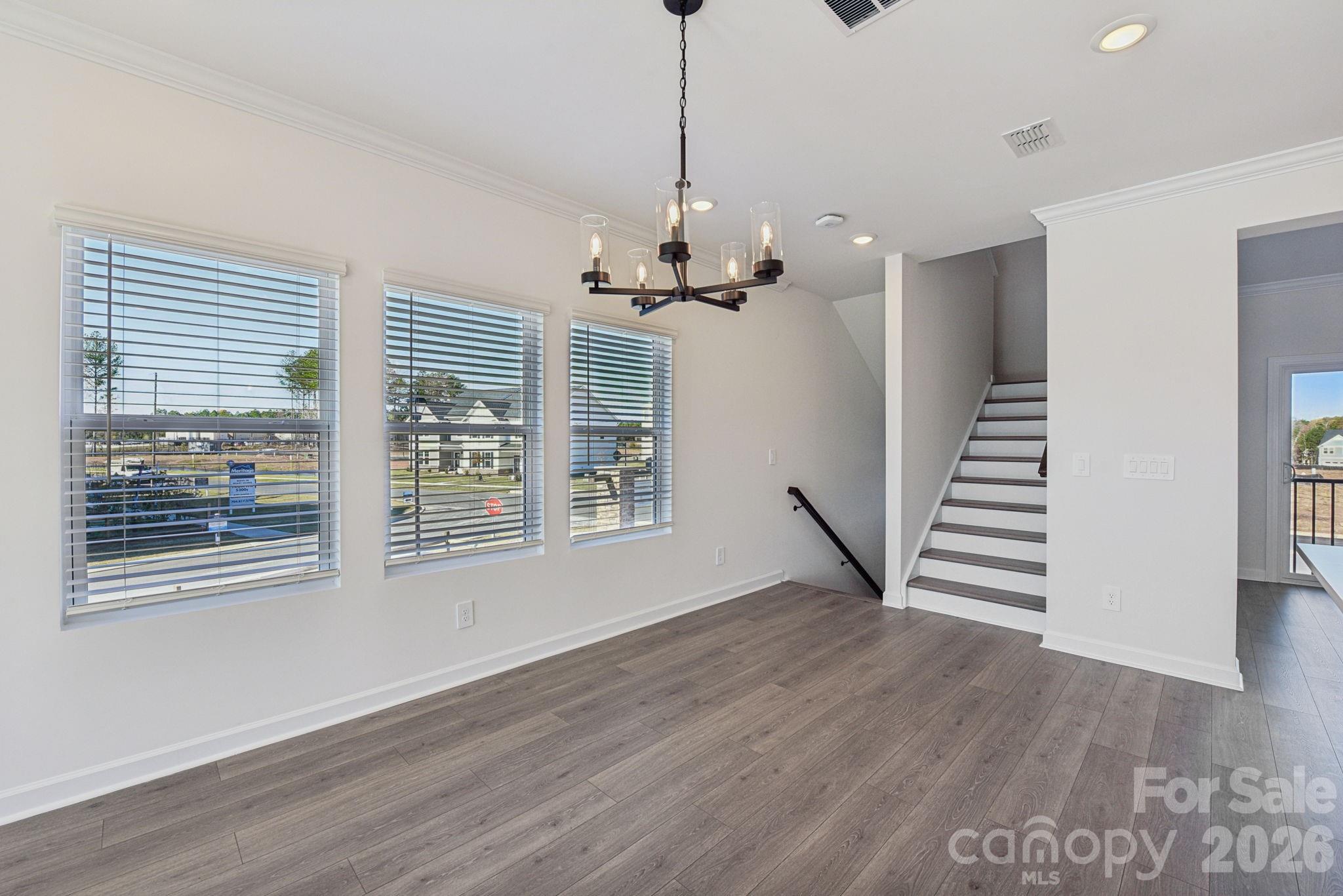 343 Golden Maple Court Fort Mill, SC 29708 - Photo 3 of 19 a view of empty room with wooden floor and fan