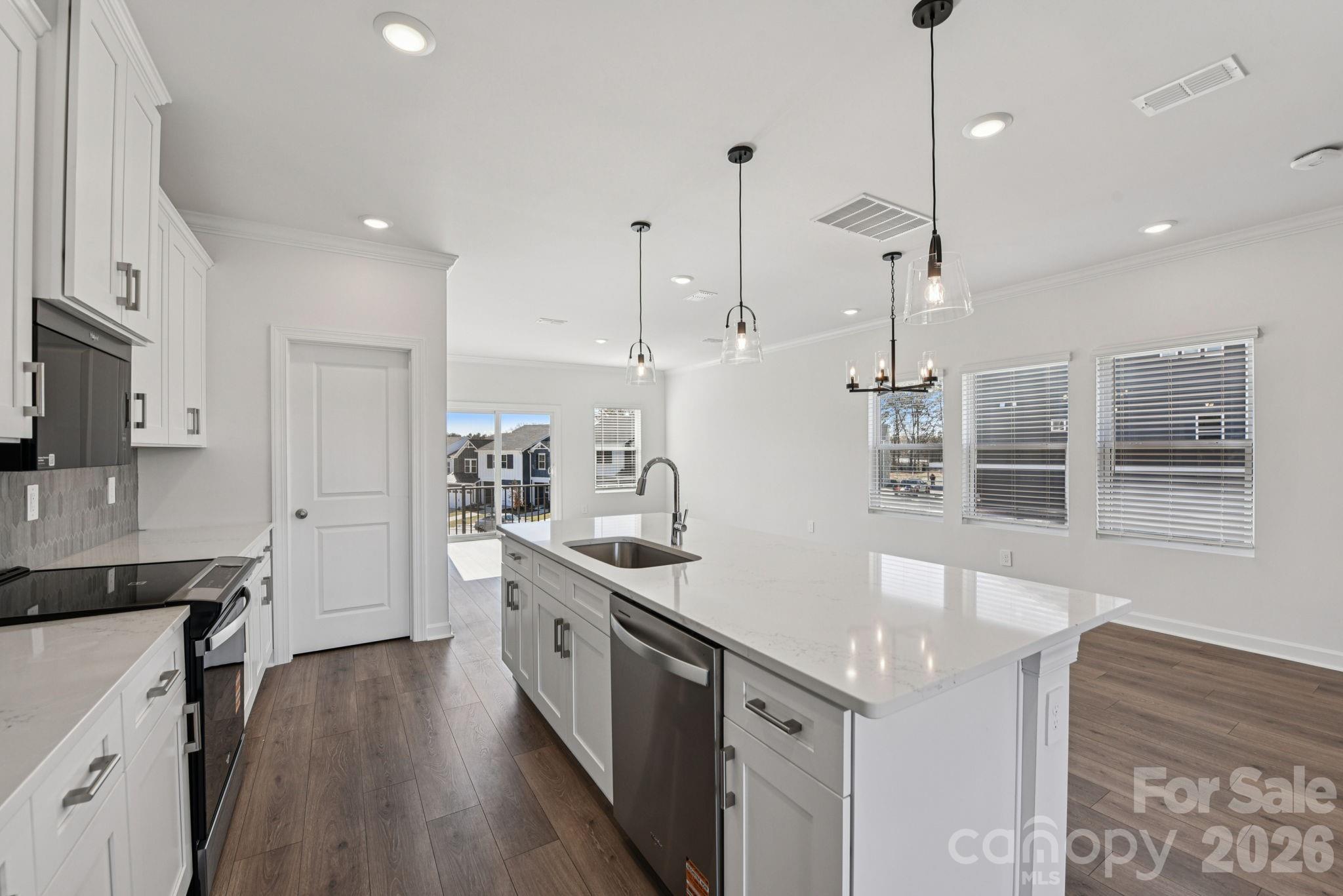 343 Golden Maple Court Fort Mill, SC 29708 - Photo 10 of 19 a kitchen with stainless steel appliances granite countertop a sink a stove and a wooden floors