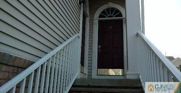 19 Raritan Reach Road South Amboy, NJ 08879 - Photo 5 of 6 a view of staircase with wooden floor and white walls