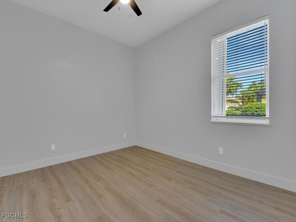 11081 Mahogany Run Fort Myers, FL 33913 - Photo 26 of 50 an empty room with a window and a ceiling fan