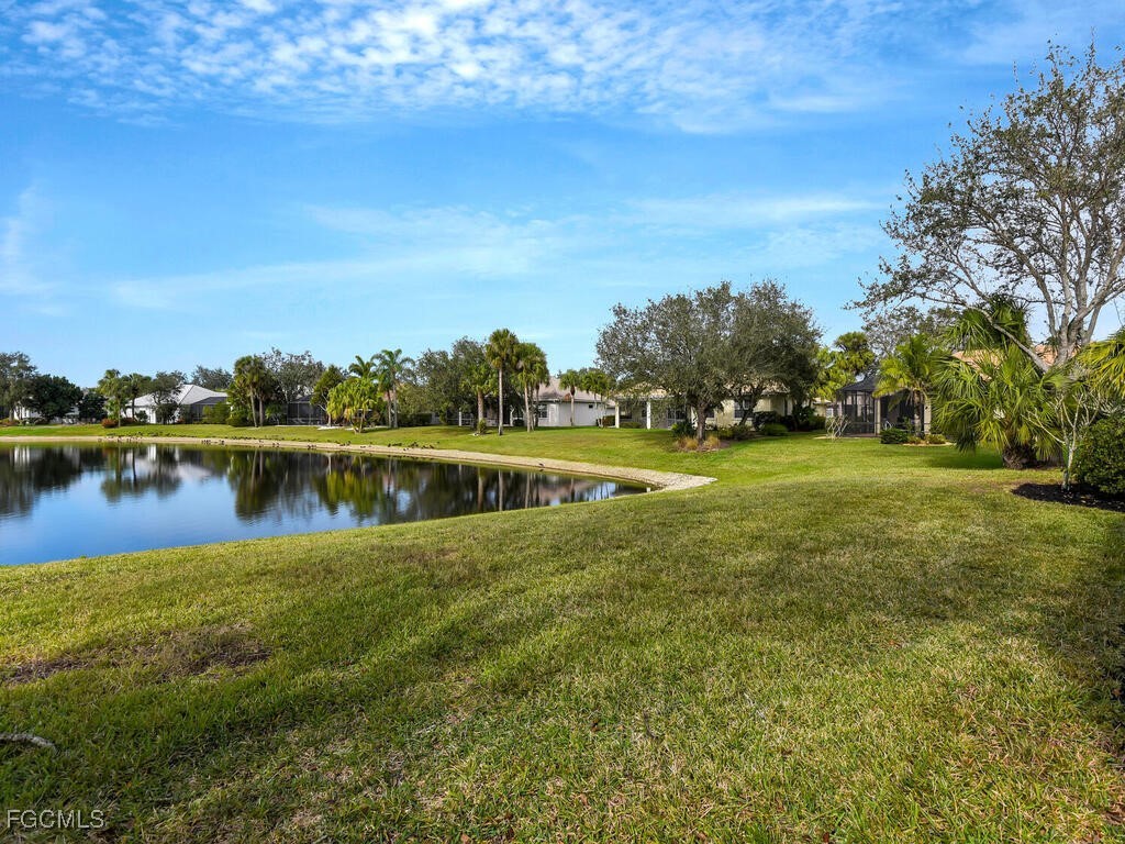 11081 Mahogany Run Fort Myers, FL 33913 - Photo 34 of 50 a view of a lake with houses in the back