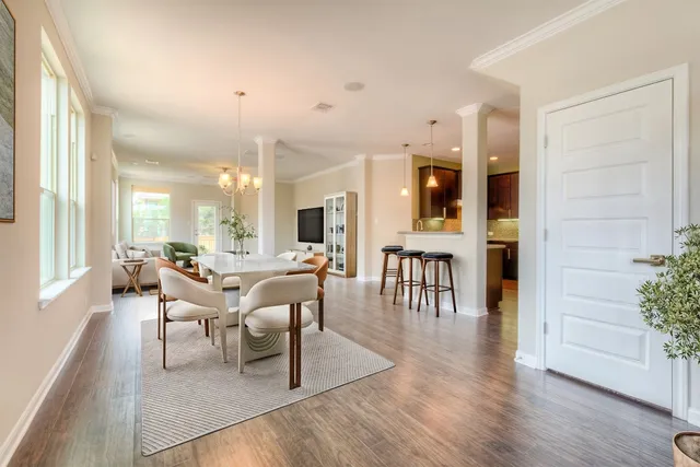 a kitchen with stainless steel appliances granite countertop wooden cabinets a oven a sink and a large window